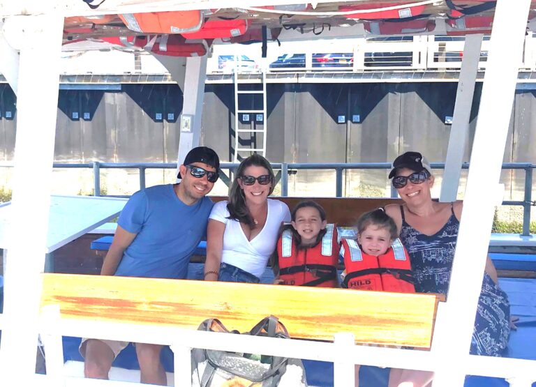 A family with their children wearing USCG approved life jackets aboart American Beauty II on Long Wharf in Sag Harbor