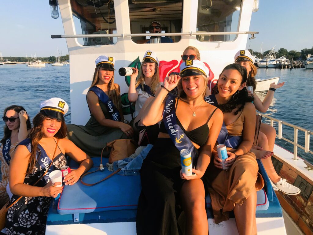 Bachelorette party photo on the bow of American Beauty II in SHelter Island Sound