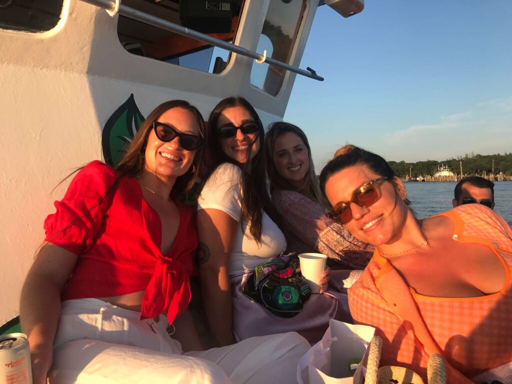 Guests enjoying a sunset aboard American Beauty II in Sag Harbor
